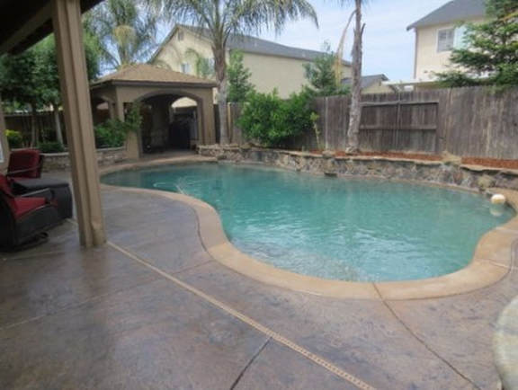 This is an image of a pool deck by a Tracy pool deck contractor