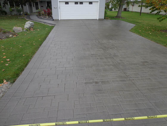 This is a picture of a neatly done concrete driveway repair, Tracy, California